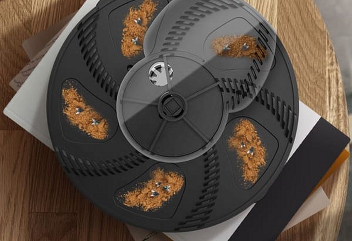 Top view of the trap with bait in each slot of the turning disc
